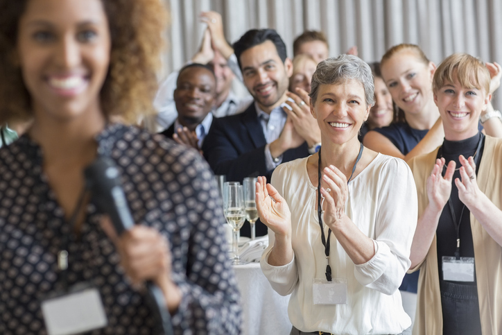 Group of people applauding after speech during conference