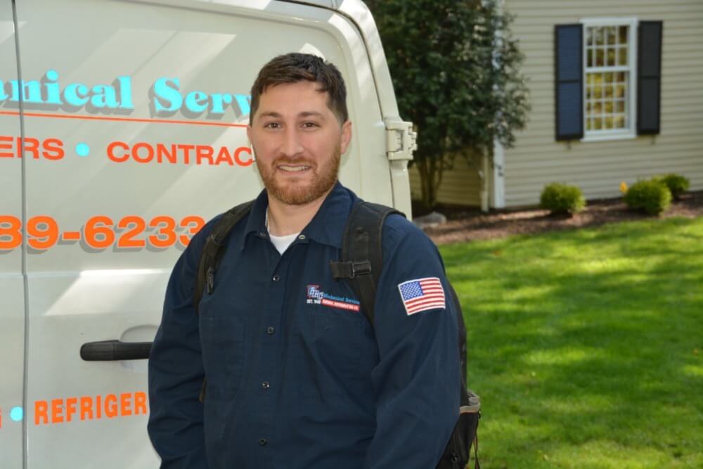 HVAC-tech-in-front-of-truck