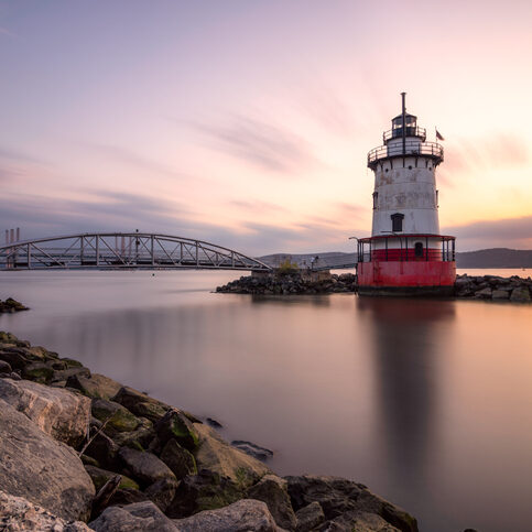 Tarrytown Light on the Hudson River in New York, with the Governor Mario M. Cuomo Bridge (formerly the Tappan Zee bridge) in the background.